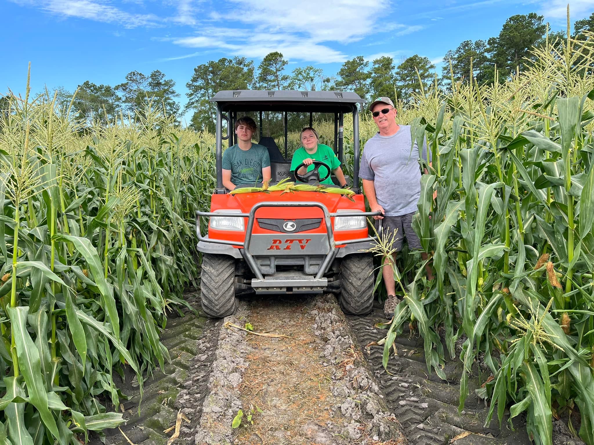 The Hart family standing together on the farm